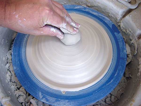11 Add a small ball of clay to the bottom of the slab to create the foot. 