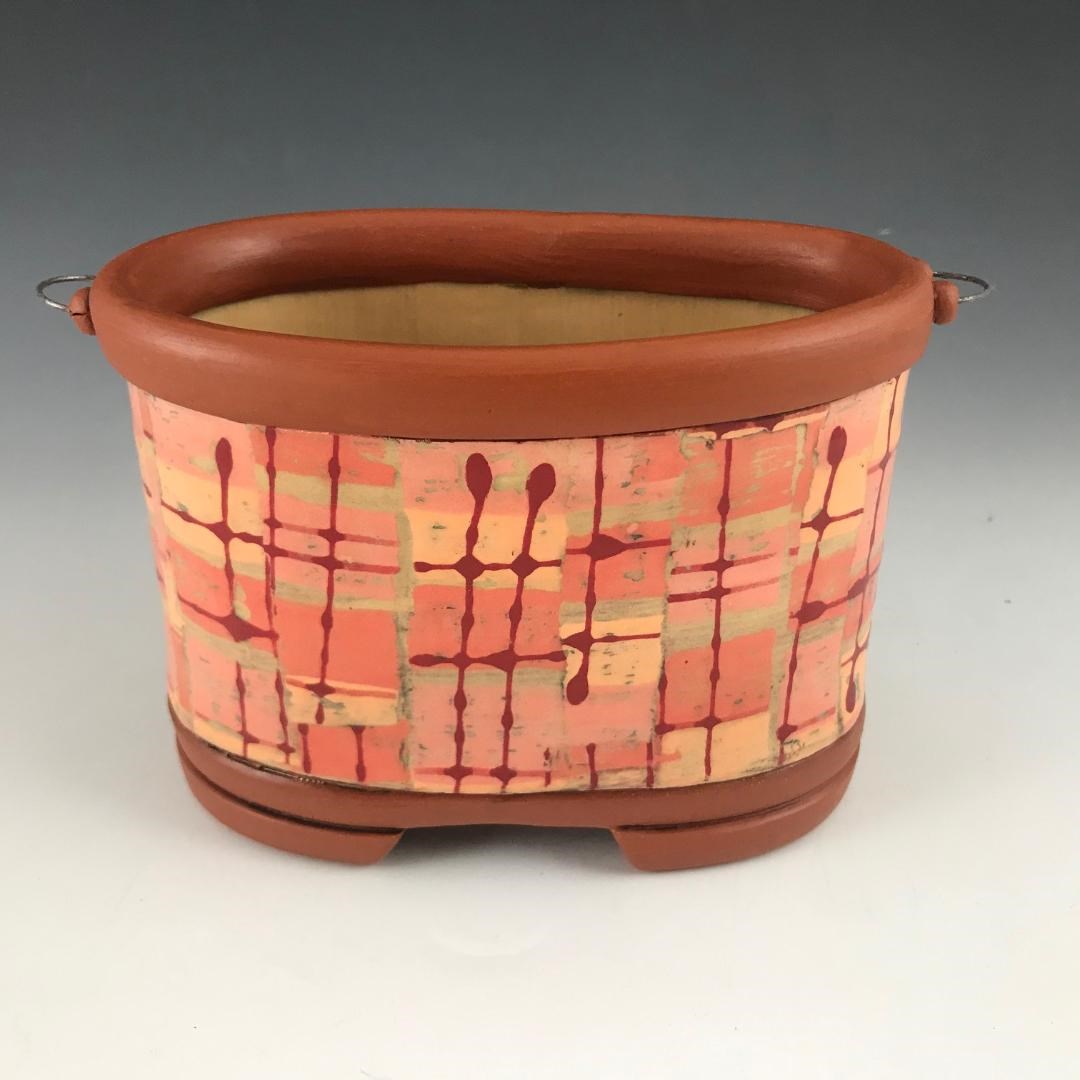 Janet Stewart, Flower brick, 8 in. (20 cm) in length, earthenware, underglaze slip trailing, newsprint transfer with colored slips, black copper oxide wash, terra sigillata, fired to cone 05, 2020. /ican/portfolio/stewart-janet/