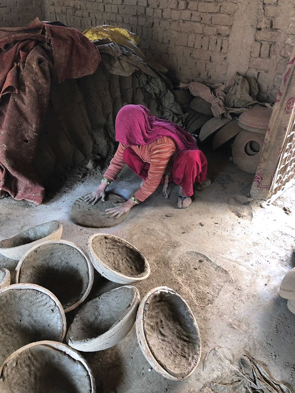 1 A potter prepares a clay slab for use. The slab is flattened into a disk using a repeated slapping motion, working in a spiral from the center to the edges.