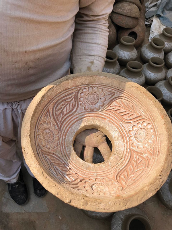 2 A close-up view of the incised pattern on the inside of one of the press molds used to make the top of a water jar.