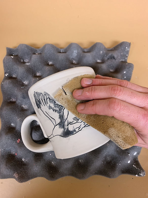 4 Wipe the excess underglaze away with a damp natural sponge.