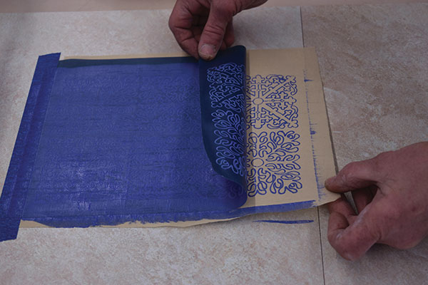 7 Lift up the bottom edge of the stencil carefully. If the print is not perfect, you can put it back down and squeegee it again.