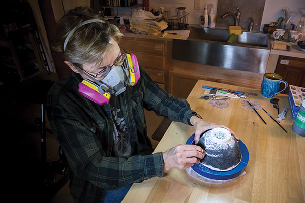 9 Using a sharp metal rib, scrape the excess underglaze off of the surface leaving it in the recesses only, then bisque fire.