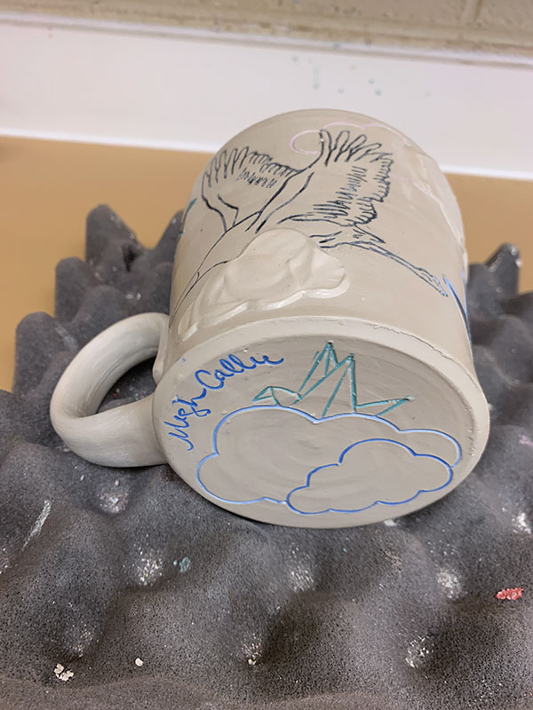 12 Carve a mishima drawing on the cup’s bottom, allow the cup to become bone dry, then bisque fire.