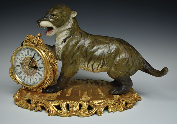 17 Ariel Bowman’s Gnaws Iron, Bites Steel, 19 in. (48 cm) in width, earthenware, fired to cone 5 in oxidation, gold leaf, clock insert, 2019.