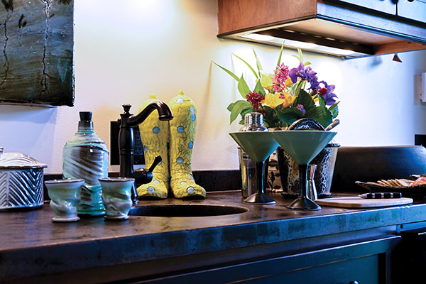 4 From left to right: Charles Timm-Ballard’s wall tile, David Hiltner’s carved silo jar, Matt Long’s celadon whiskey set, Tom Bartel’s boot sculpture, Matt Long’s Martini glasses, and an ice bucket by Kirk Jackson. 
