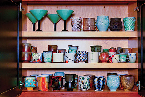 3 The cabinet above the bar features a variety of cups, including many made by residents, staff, and visiting artists of Red Lodge Clay Center. 