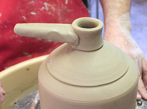 15 Add a dab of water to the scored face of the handle and attach it to the spout.