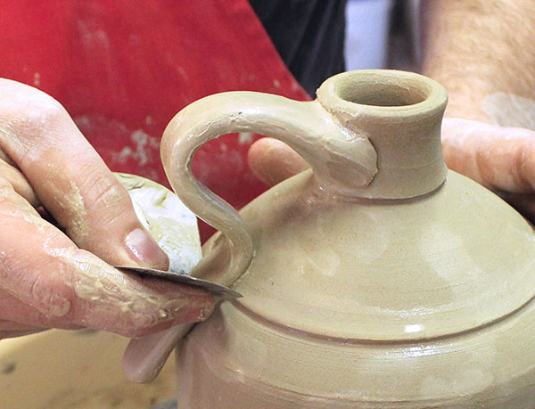19 Cut off the excess clay with the edge of a metal rib, then clean up the area.