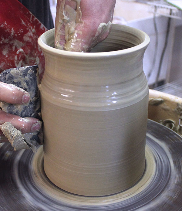 4 Start shaping the wall of the cylinder with a wooden rib tool.