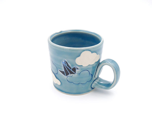 Origami Crane Mug (alternate view), 4 in. (10 cm) in height, porcelain, mishima, underglaze, paper stencils, sgraffito, glaze, fired to cone 6 in oxidation, 2019.
