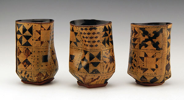 3 Yinka Orafidiya’s Freedom Cups, 4 in. (10 cm) in height, Underground Railroad quilt code printed on handbuilt dark stoneware, underglaze, slip, glaze, fired to cone 6 in an electric kiln.