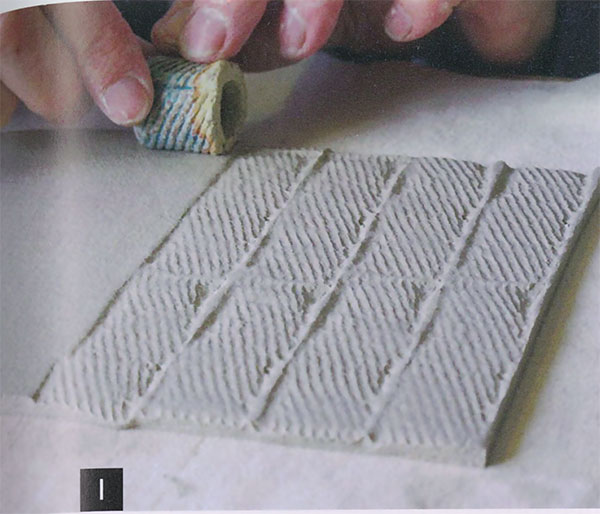 1 Texture the slab by stamping it or rolling over it with a bisque-fired roulette.