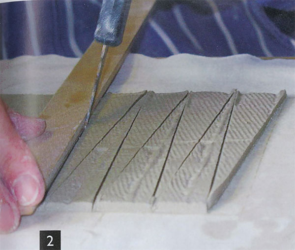 2 Cut elongated triangles out with a sharp knife pointed directly down.
