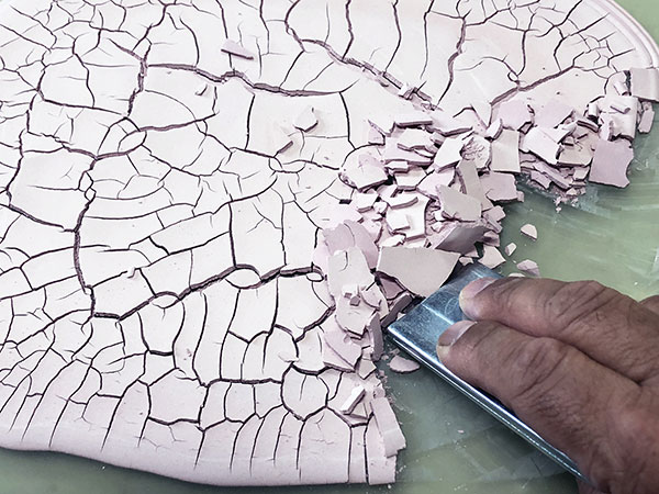 2 Scrape the dried glaze off of the frosted glass with razor blade.