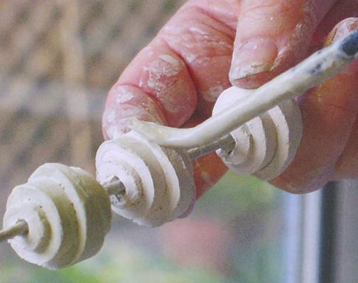 7 With the beads threaded on a knitting needle, brush on a stain or glaze.