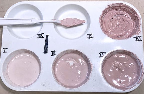 7 Mix the progression tests of dried glaze with the liquid underglaze. Use a muffin pan with individually labeled sections to keep the progression tests separate.