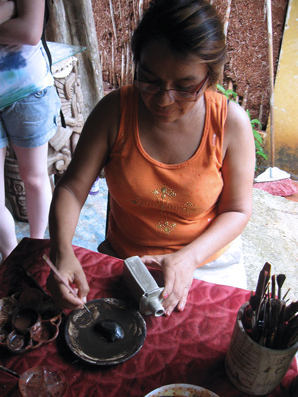 9 Patricia painting a piece in her studio.
