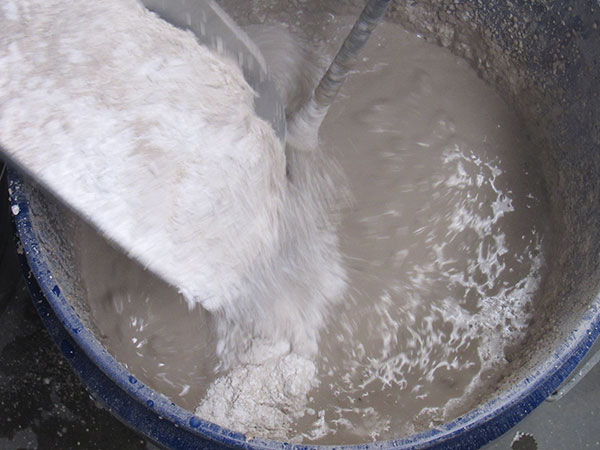 2 Slowly add the dry ingredients to the water.