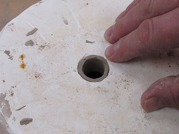 6 A clay wall forms as it sits in the plaster mold.