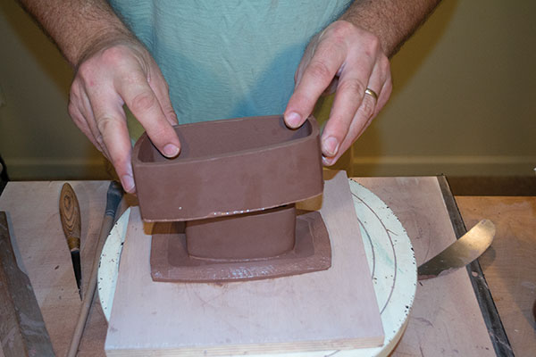 4 Next, score, add slip, and attach the exterior wall to the base slab.