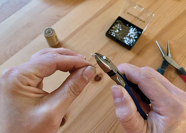1 While wearing eye protection, use cutting pliers to clip the ball off the end of each sewing pin.