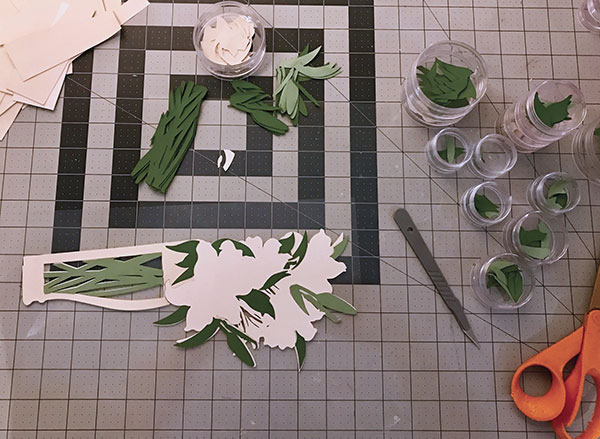 C The cut shapes of greenware porcelain are sorted by shape—like a puzzle—and assembled using tweezers, a scalpel, and slip.