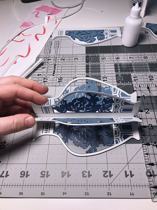 D The fired porcelain pages are carefully bound together using a paper binding, PVA glue, and thread.