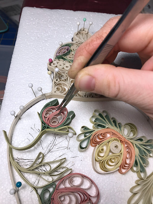 E Thin strips of greenware porcelain are rolled, curled, and coddled into a design.