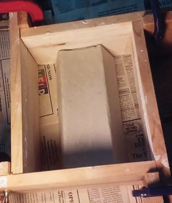 3 Pouring gypsum plaster over a master mold produces a working mold, used for forming the bricks.