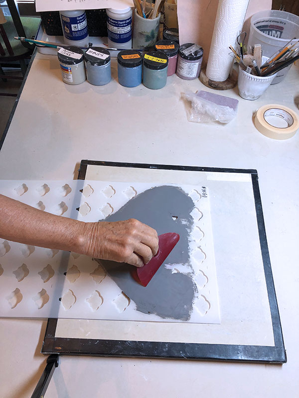 4 Use a flexible rib to remove any excess colored slip.