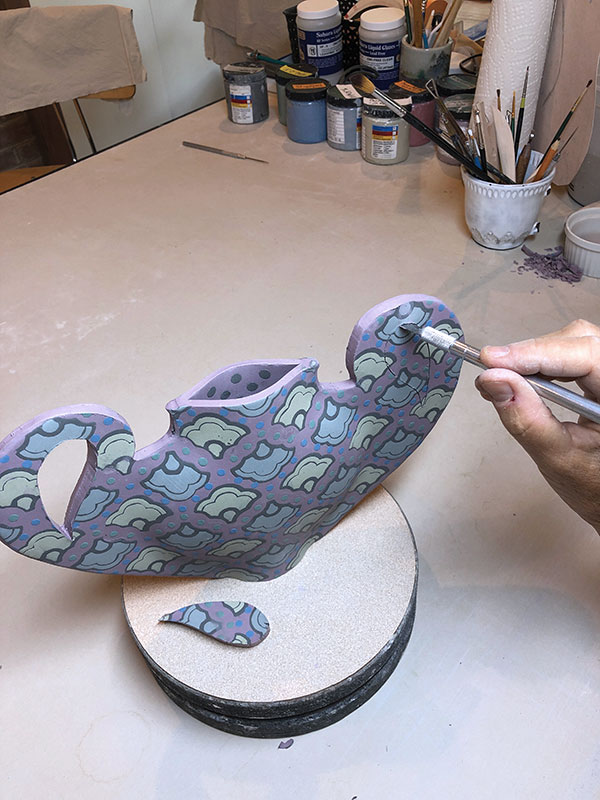 12 Trim excess clay from the edges. Cut out the handle interiors with a sharp knife.