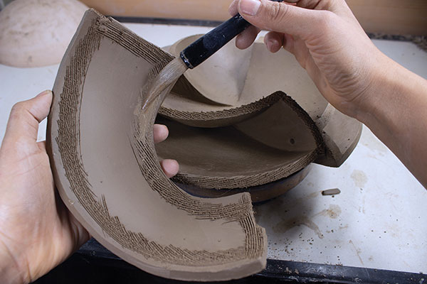 18 Make the slab a bit larger to allow for error, keeping in mind that an altered slab being a three-dimensional object will fit differently than a piece of paper. Score, slip, and attach the final slabs.