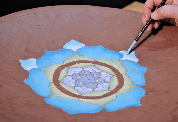 7 Continue painting the design, working your way outward, and selecting colors to differentiate each concentric ring of petals.