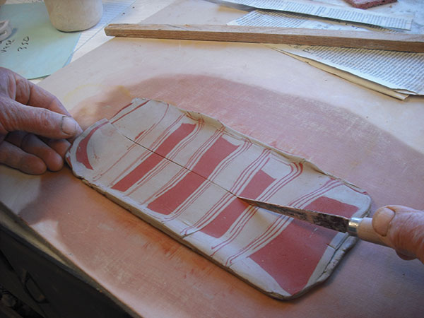 15 Roll out the slab into a square shape, leaving bulges at each end.