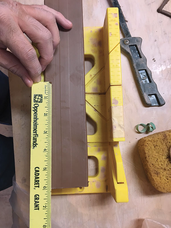 2 Place the stiffened tube in a miter box and make a cut at the 6-inch mark.