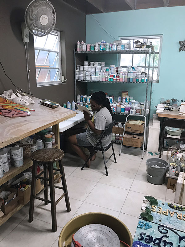 8 Carlisse working at the painting station in the studio.