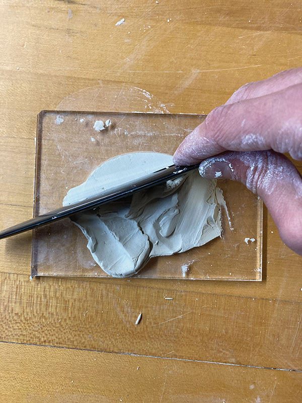 1 Using a 1/4-inch Plexiglass die, press clay into the die, then scrape the surface flat.
