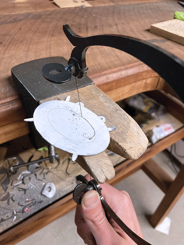9 Insert the saw blade into the pierced center hole and cut that space out.