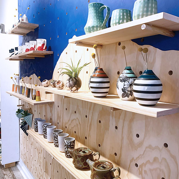 2 Wall display of handmade ceramics by Stefani Threet and artists she represents at Ceramic Concept in Philadelphia, Pennsylvania.