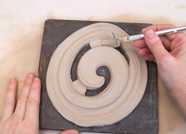 4 Cut out the spiral with an X-Acto knife, leaving small connector tabs.