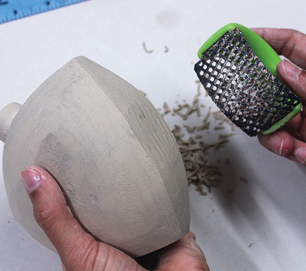 8 At the hard leather-hard stage, Surform a small flat area on one side so that the flask can sit upright, then rib smooth.