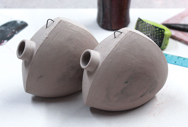 9 Insert a nichrome wire elbow in the leather-hard clay. After the final firing, this will be used to secure the cork to the body.
