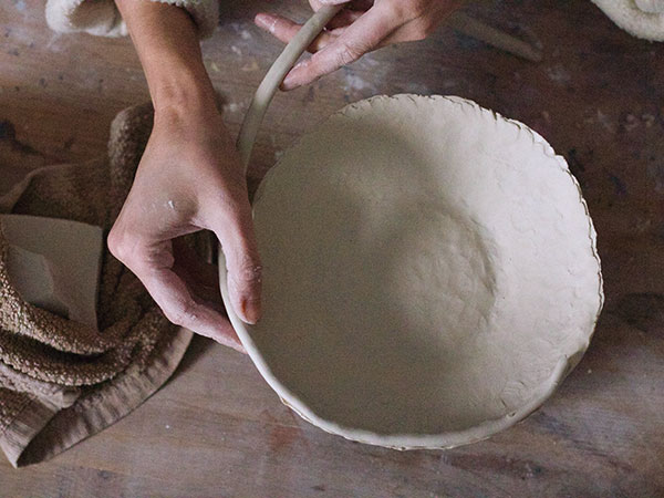 2 Add coils to the inner rim, and work into the form from the inside and outside.