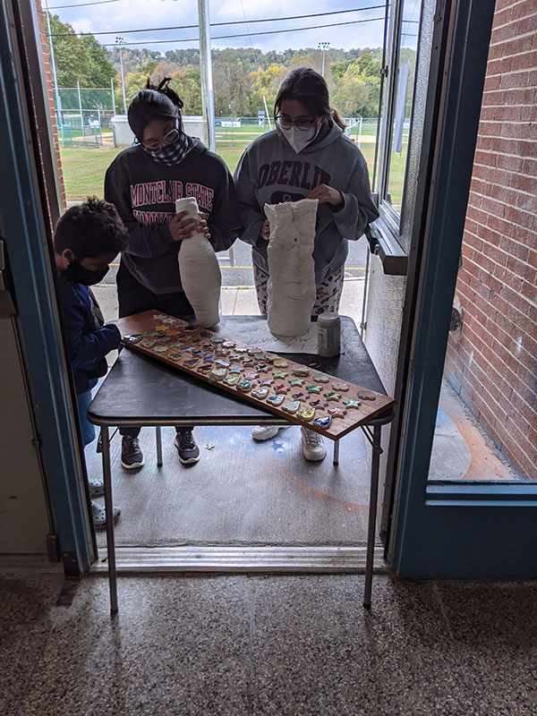 5 Samantha and Ambar Perez allowing their brother to help select colors from the test tiles.
