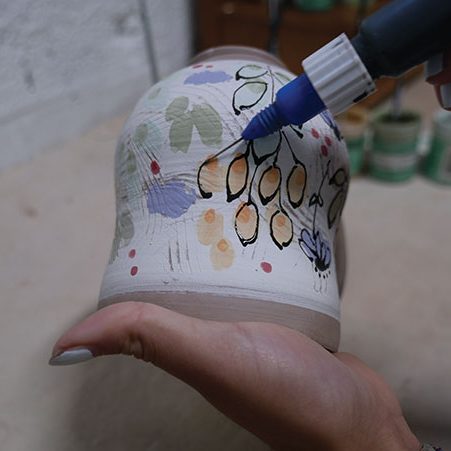 5 Outline your colorful design using the black underglaze-filled applicator.