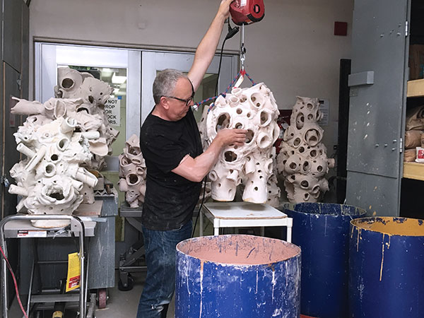 7 Christopher Miles preparing a sculpture to be glazed.