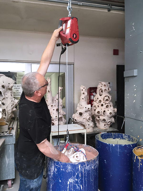 10 The electric hoist has lowered the sculpture into the glaze almost fully.