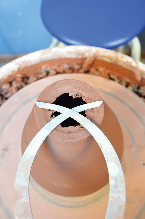1 Measure the base of the freshly thrown pot with calipers.