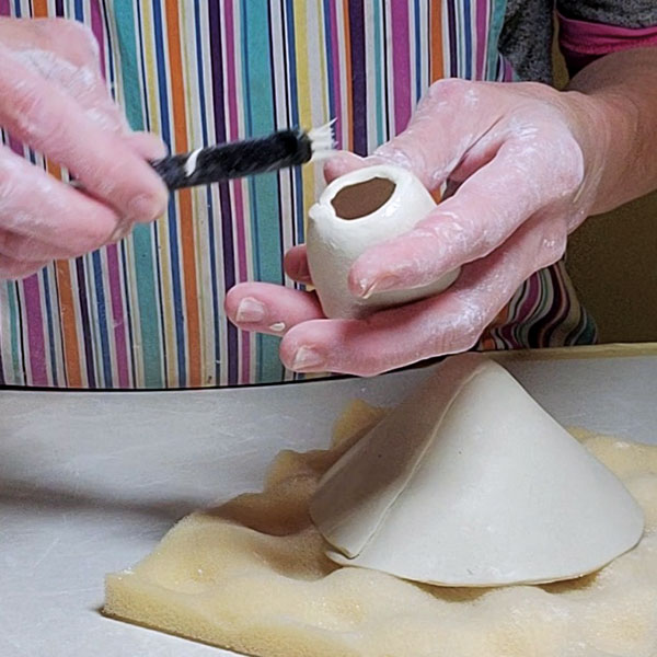 3 Gently roll the narrower end of the foot on a tabletop to form a rounded edge.